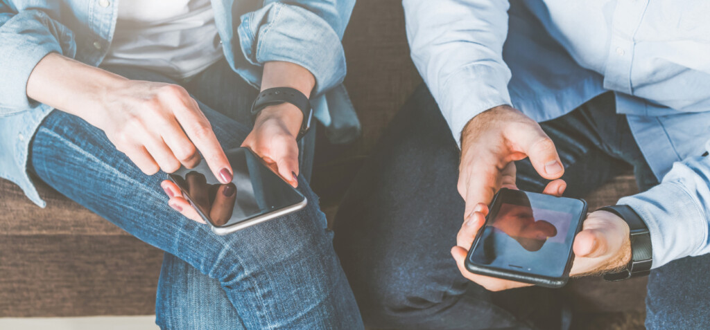 Two persons using their smartphones