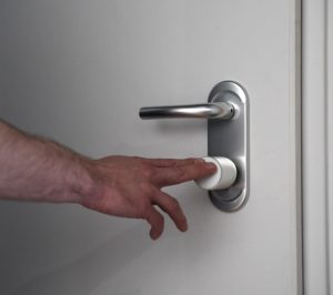 A hand pressing on a tedee smart lock