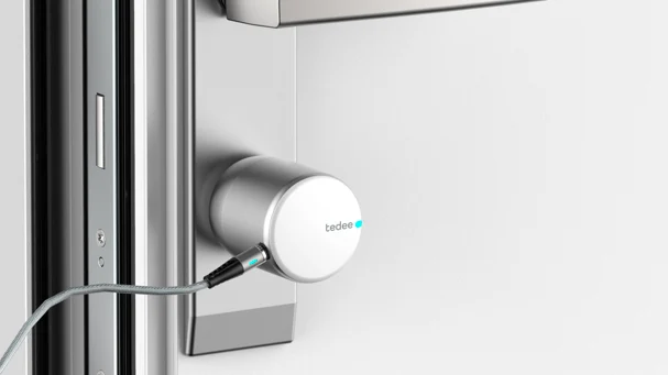 A tedee smart lock plugged into charging