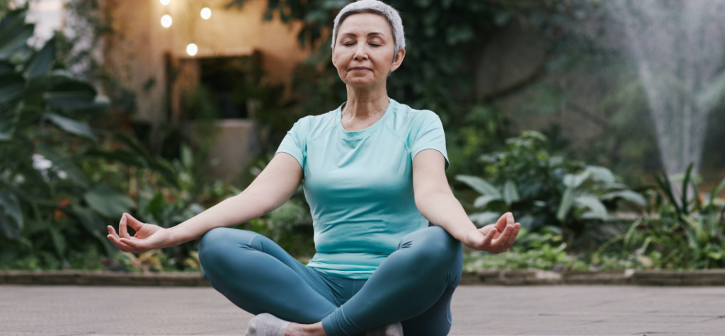 A woman meditating in the garden