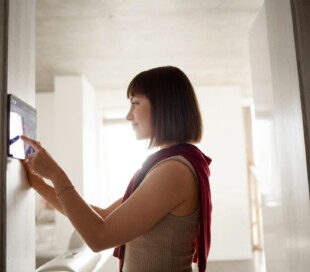 young woman using home technology 2 scaled