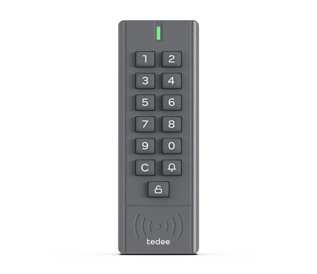An image of a Tedee Keypad, This vertical, rectangular smart door lock accessory is dark grey and features a series of buttons arranged in two columns. At the top, an LED indicator is followed by numerical buttons from one to zero, a 'C' button for cancelling, a bell button for notifications, and an unlock button. Each button has white numbering and symbols. Below the buttons, symbols indicate wireless connectivity and display the Tedee logo.